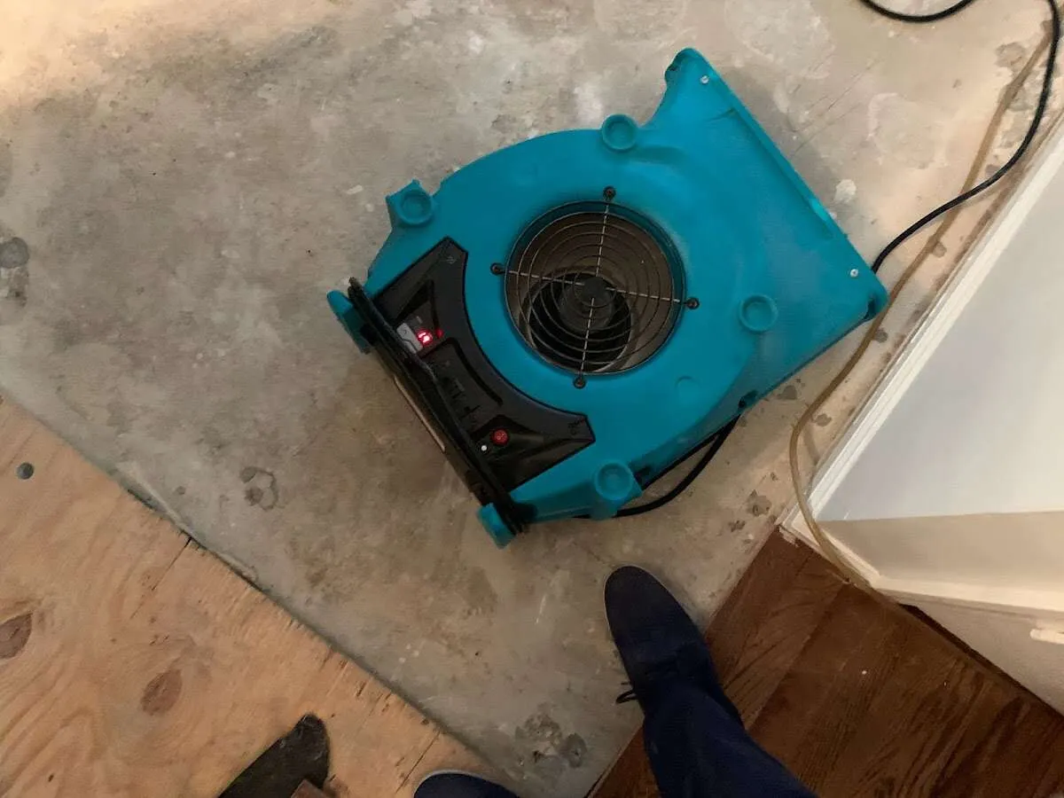 Air mover drying subfloor during Leak Detection & Repair in Canal Fulton